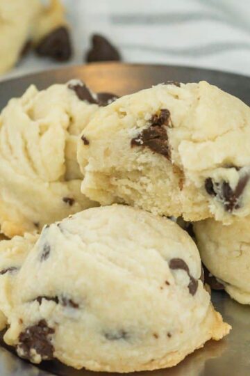 A plate of chocolate chip cookies is displayed. The cookies have a soft texture with visible chocolate chips embedded in them.