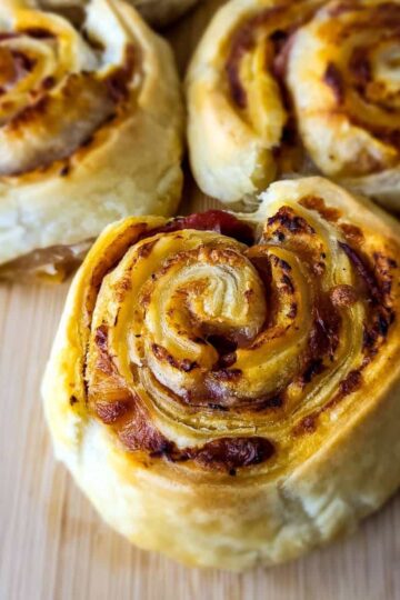 Three pieces of puff pastry pizza rolls.