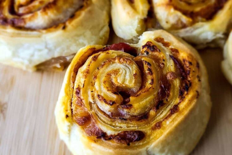 Three pieces of puff pastry pizza rolls.