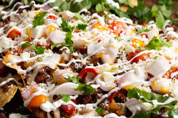 Loaded sheet pan nachos with traditional mexican styled toppings