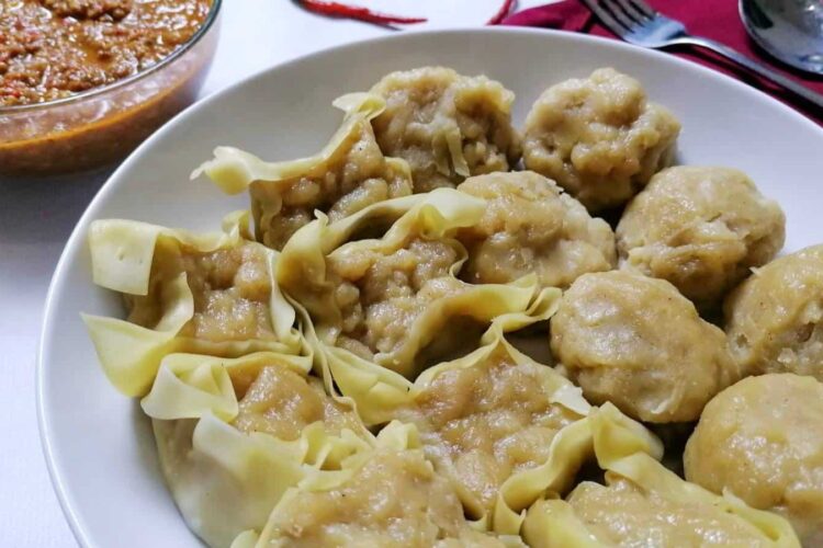 Indonesian version fish dumplings Siomay with a bowl of spicy peanut sauce.