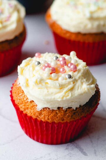 Buttercream icing with tiny pink and silver balls for decoration.
