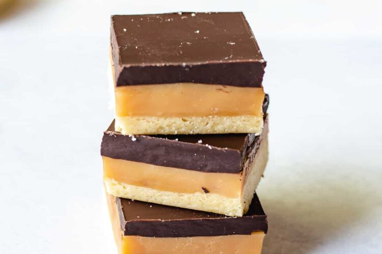 stack of 3 caramel slices on a white background.
