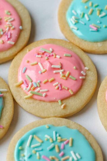 Close up image of sugar cookies decorated with pink and blue icing.