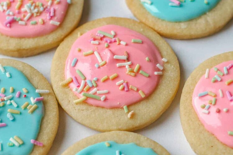 Close up image of sugar cookies decorated with pink and blue icing.