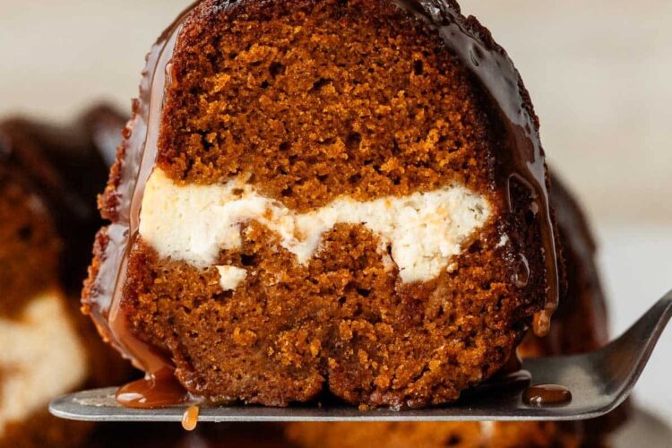 slice of pumpkin Bundt cake with cream cheese swirl inside.