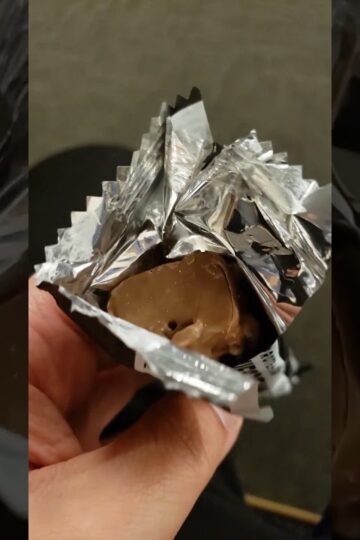 Barebells protein bar cookies and cream flavor inside the wrapper.