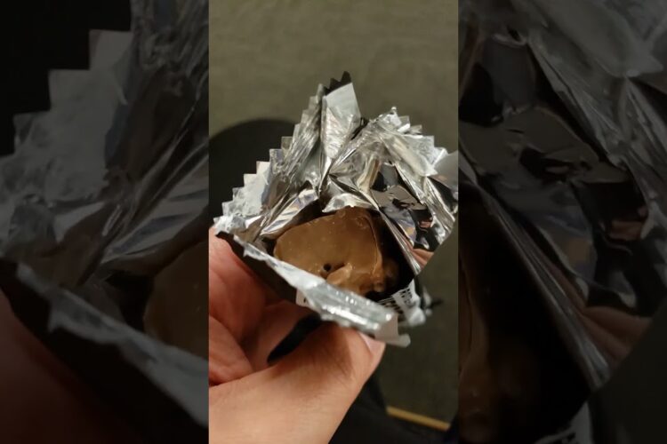 Barebells protein bar cookies and cream flavor inside the wrapper.